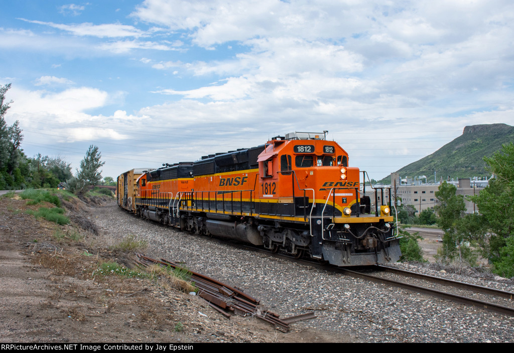 BNSF 1812 poses with part of the massive Coors Plant